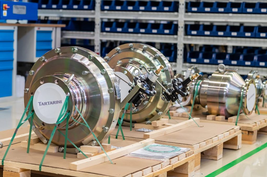 Large industrial valves stored in an organized workshop environment.